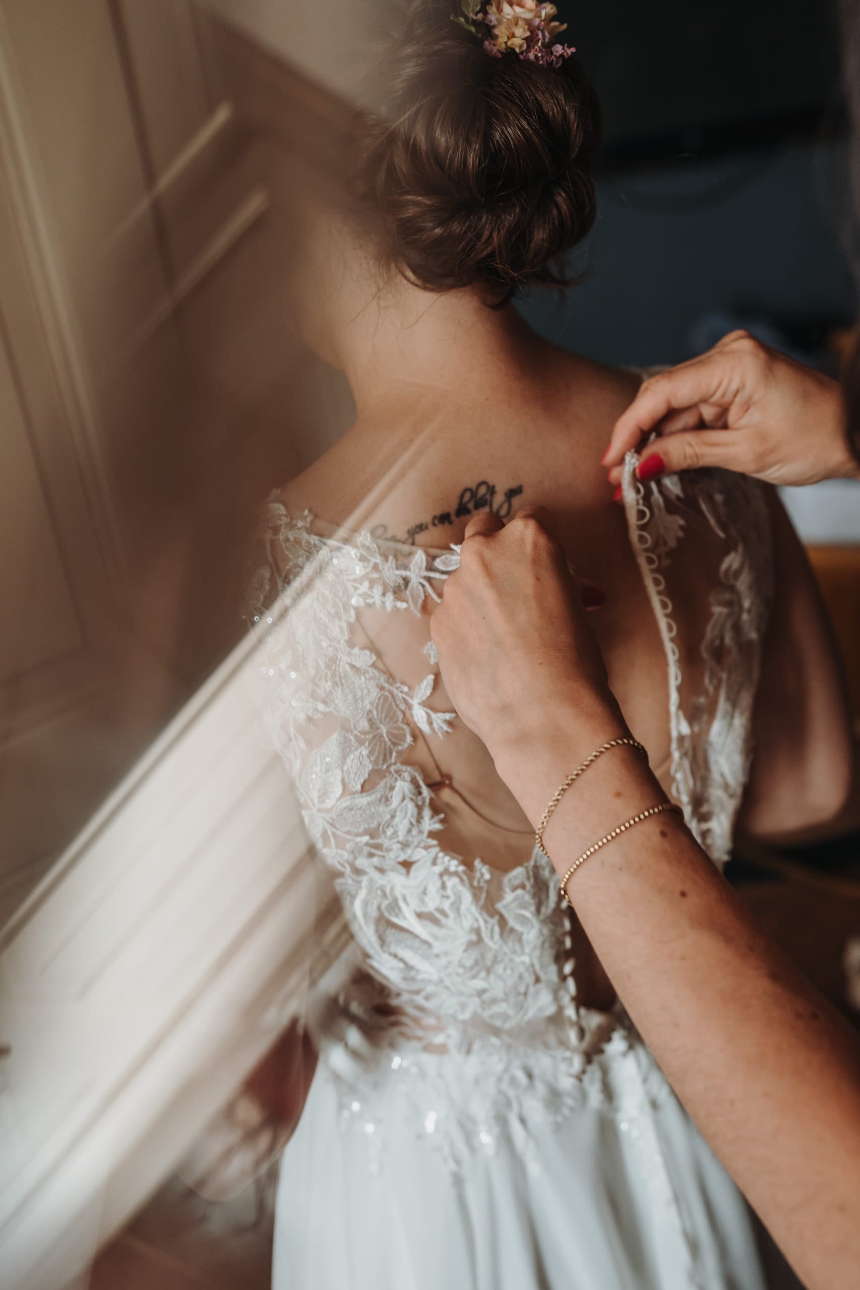Das Spitzenkleid wird am Rücken geschlossen